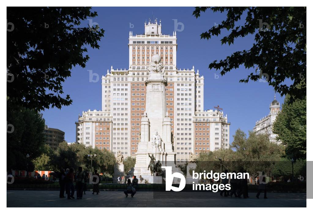 Spanish Steps - buildings of the 50s - foreground: The monument in Cervantes erige in 1928 - second ground: the building Espagna - 2005 The monument in Cervantes on the Plaza de Espana in Madrid (Spain). In the background, the Edificio de Espana, a building of the fifties. Photography 22/09/2005