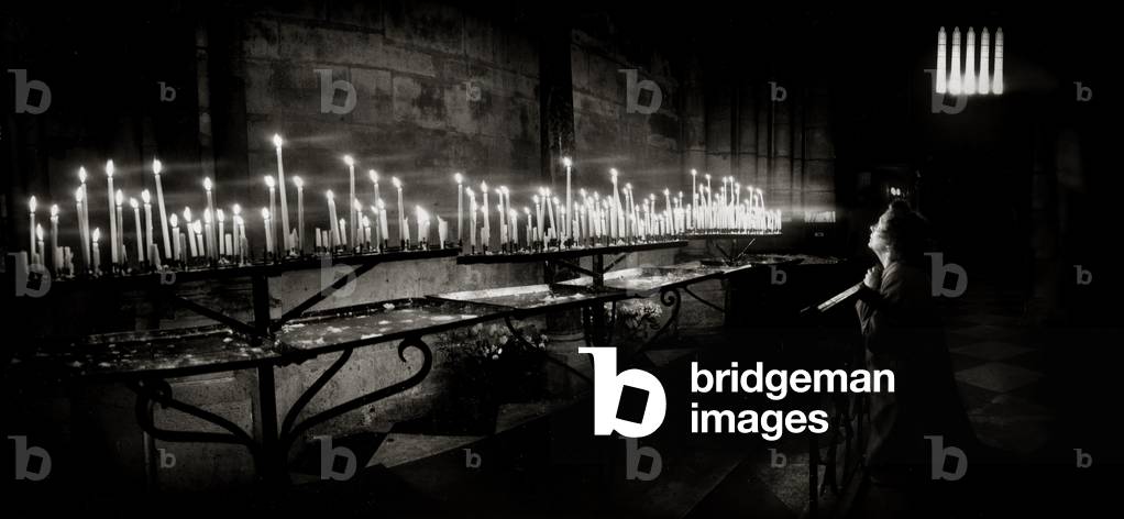 Woman at prayer, Notre Dame Cathedral, Paris (b/w photo)