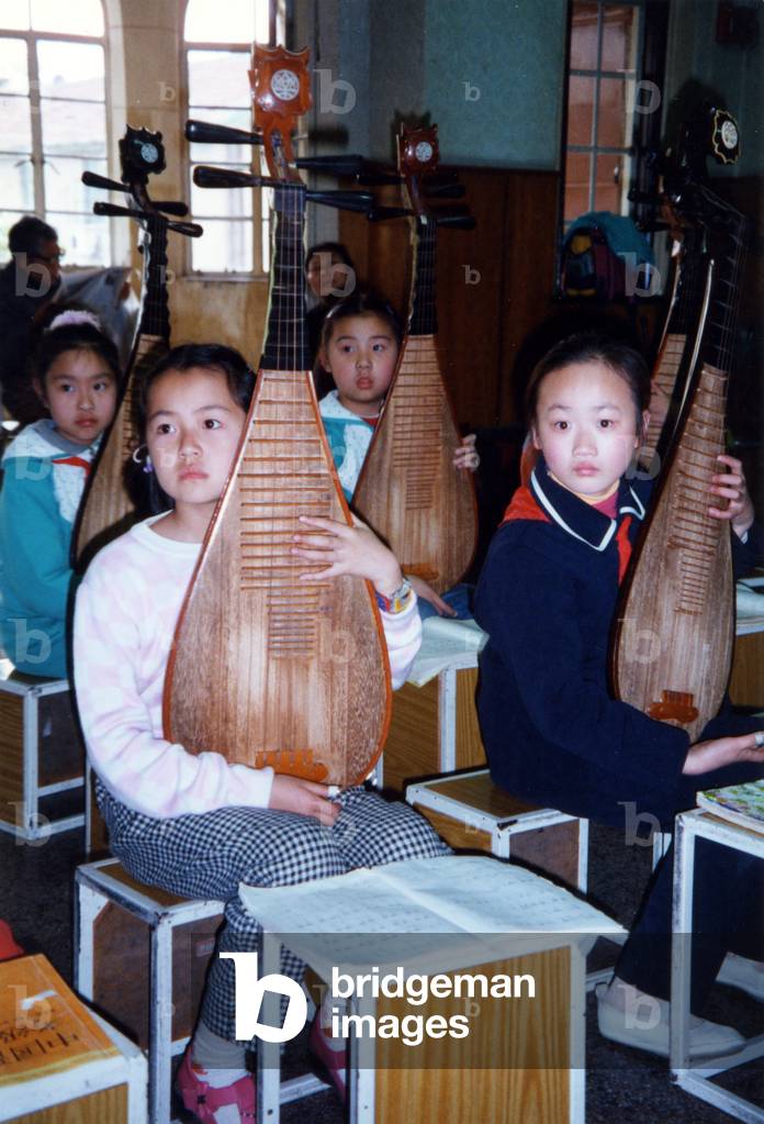 Chinese girls playing PIPA using Chinese musical notation in Shanghai music school