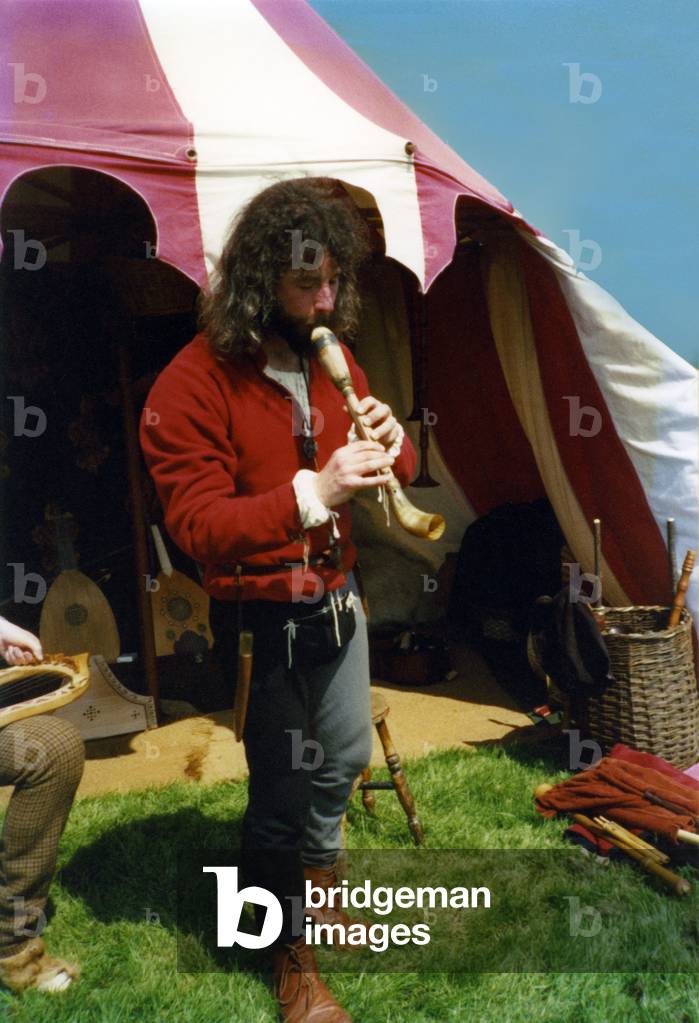 Man playing the pibcorn Re-enactor playing pibcorn - stockhorn Celtic instrument