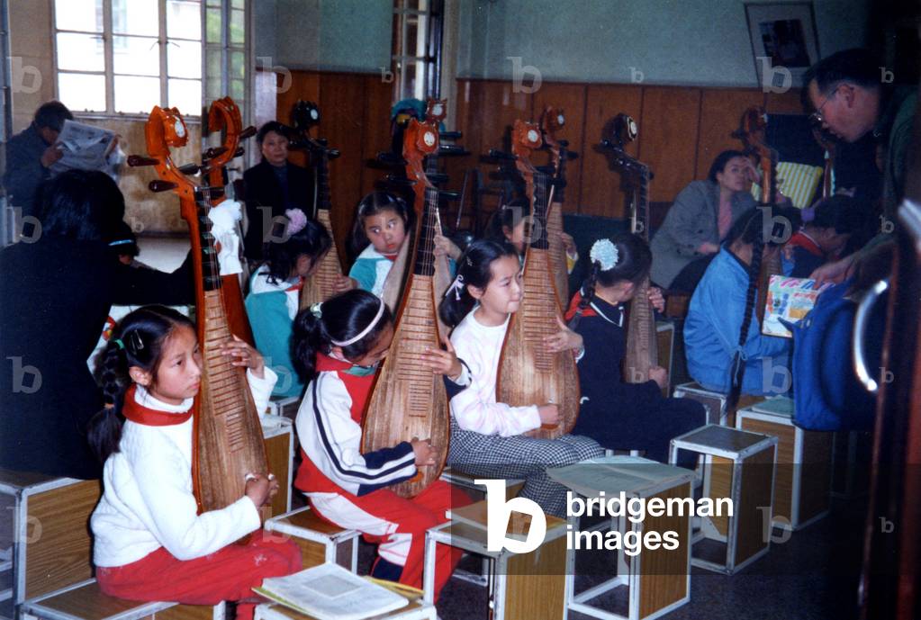 Chinese girls playing PIPA using Chinese musical notation in Shanghai music school