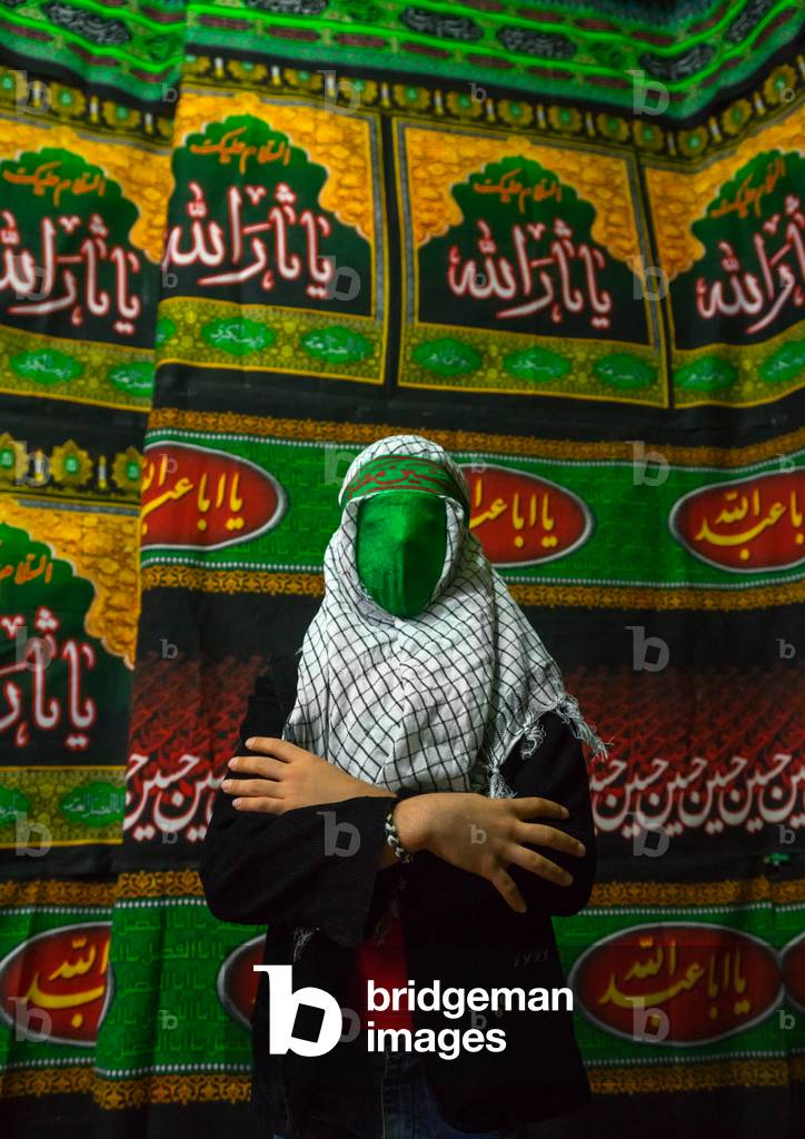 Iranian Young Man with Green Veil Covering His Face during Chehel Menbari Festival on Tasua to Commemorate the Martyrdom of Hussein, Lorestan Province, Khorramabad, Iran (photo)