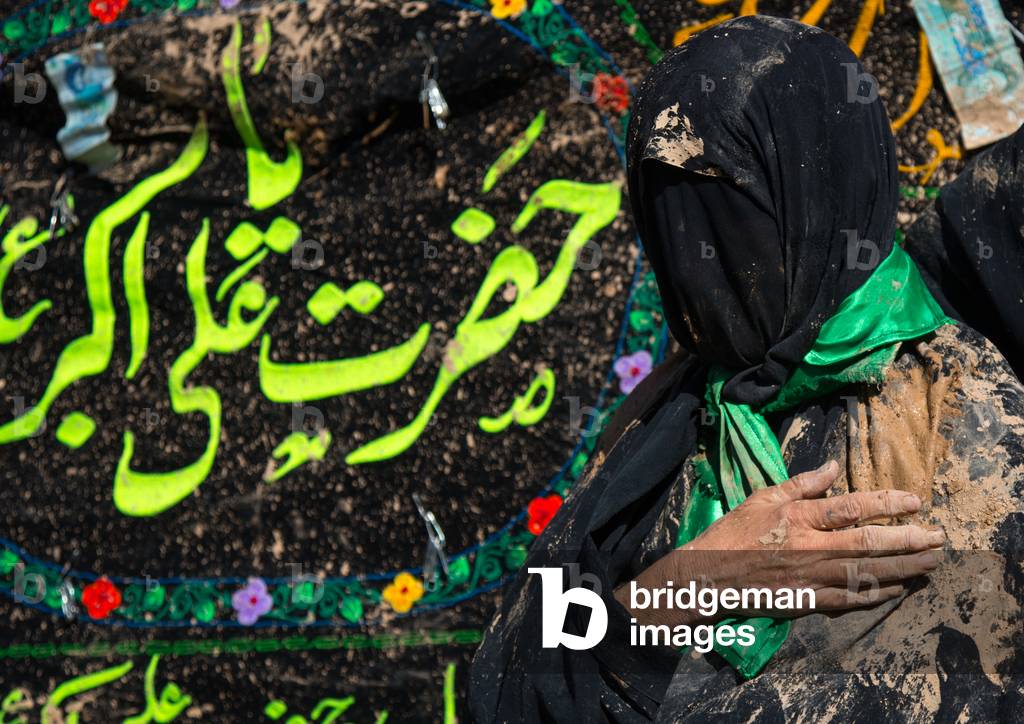 Iranian Shiite Muslim Woman Covered in Mud with her Hand on her Heart during Ashura, Kurdistan Province, Bijar, Iran (photo)