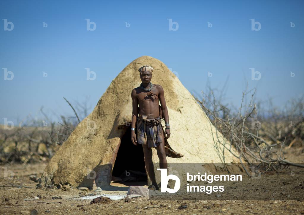 Muhimba Man in front of his Hut, Village of Elola, Angola, Africa (photo)