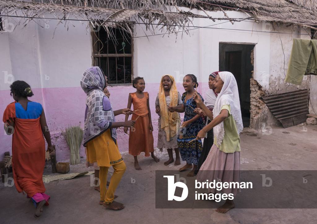 Girls dancing and singing in a courtyard, Lamu county, Matondoni, Kenya, Africa (photo)