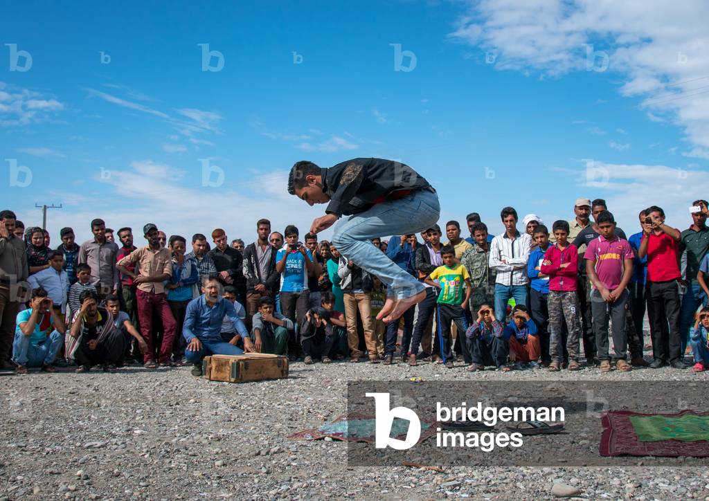 Man Jumping On Broken Glass During A Show On A Market, Hormozgan, Minab, Iran, 2015 (photo)