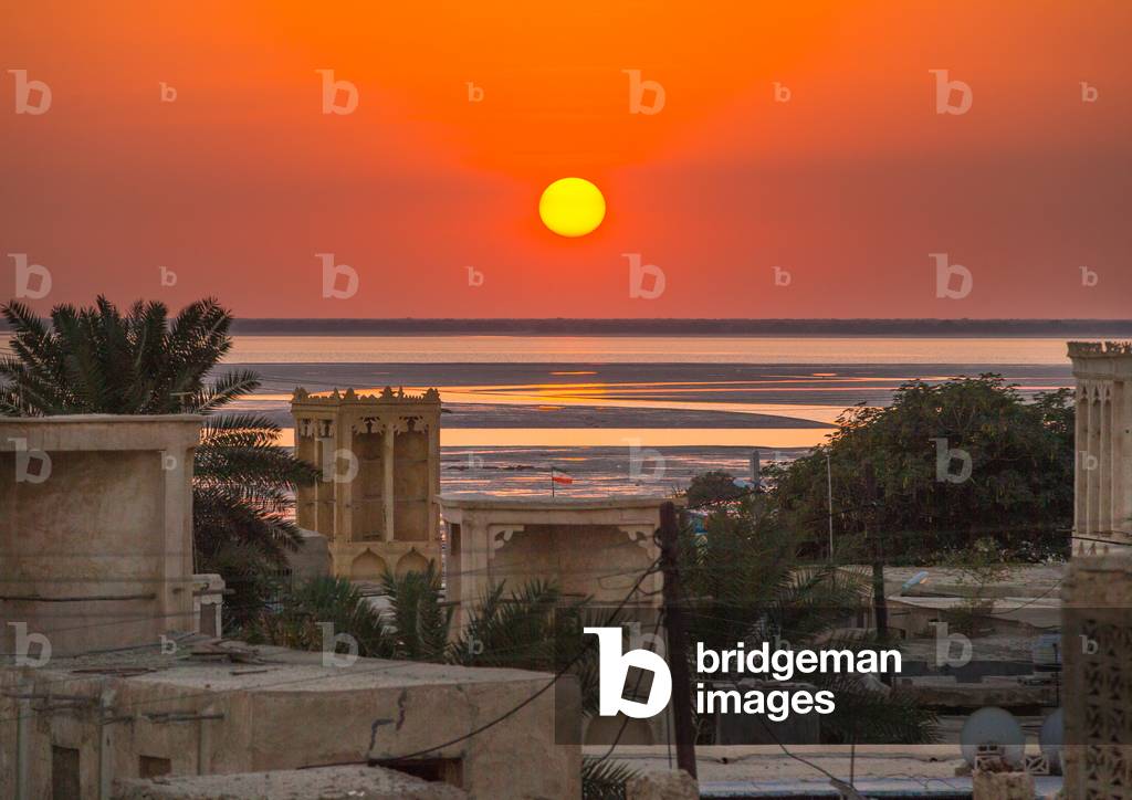Sunset Over Wind Towers Used As A Natural Cooling System In Iranian Traditional Architecture, Qeshm Island, Laft, Iran, 2015 (photo)