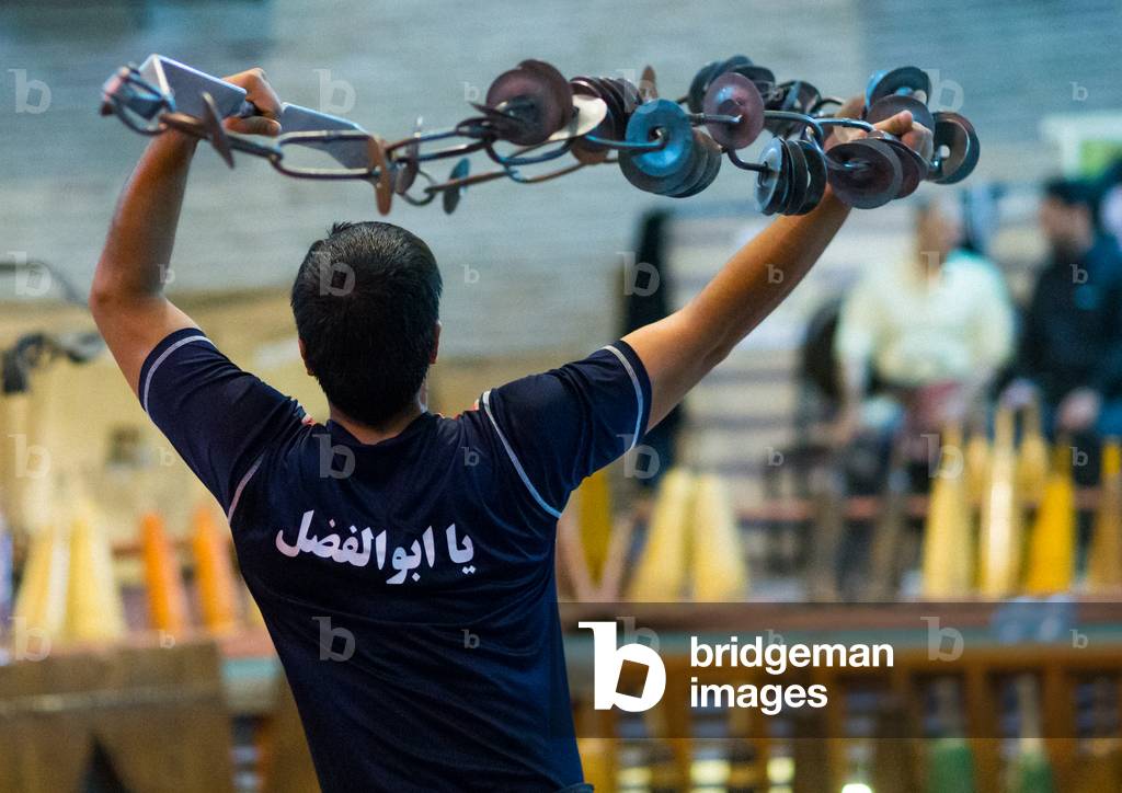 Iranian Man Training with Kabbadeh Chain and Bow at Saheb a Zaman Club Zurkhaneh, Yazd Province, Yazd, Iran (photo)