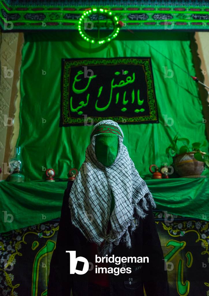 Iranian Young Man with Green Veil Covering His Face during Chehel Menbari Festival on Tasua to Commemorate the Martyrdom of Hussein, Lorestan Province, Khorramabad, Iran (photo)
