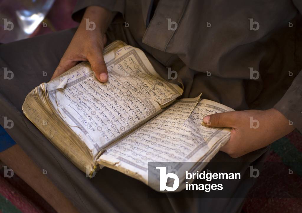 Rashaida Tribe Kid Reading Quran in a Coranic School, Kassala, Kassala State, Sudan (photo)