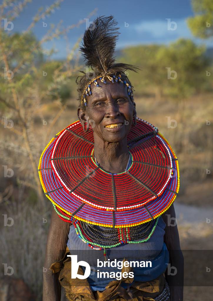 A pokot woman wears large necklaces made from the stems of sedge grass, Baringo county, Baringo, Kenya, Africa (photo)