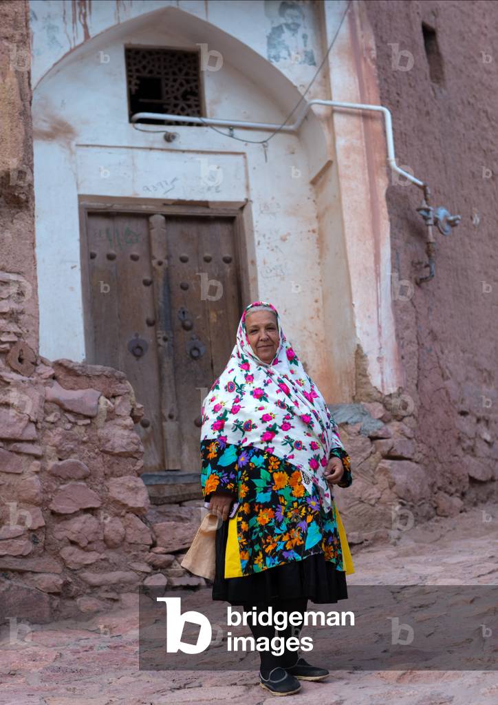 Portrait of an Iranian Woman wearing Traditional Floreal Chador in Zoroastrian Village, Isfahan Province, Abyaneh, Iran (photo)