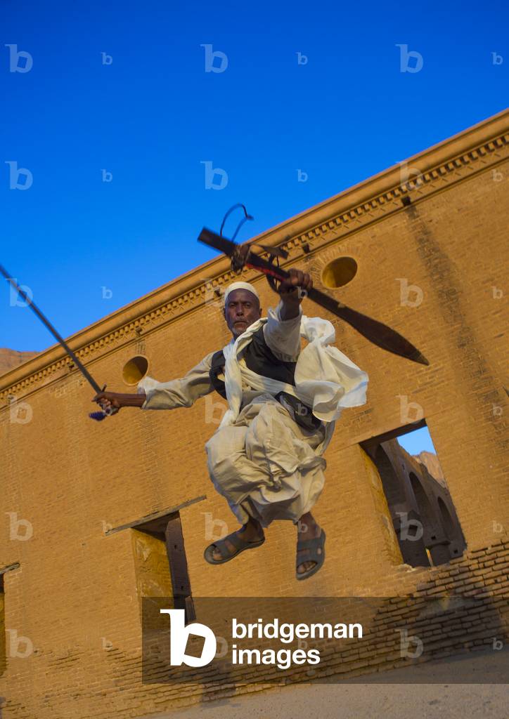 Beja Tribe Man Dancing in Front of The Khatmiyah Mosque at The Base of The Taka Mountains, Kassala, Kassala State, Sudan (photo)