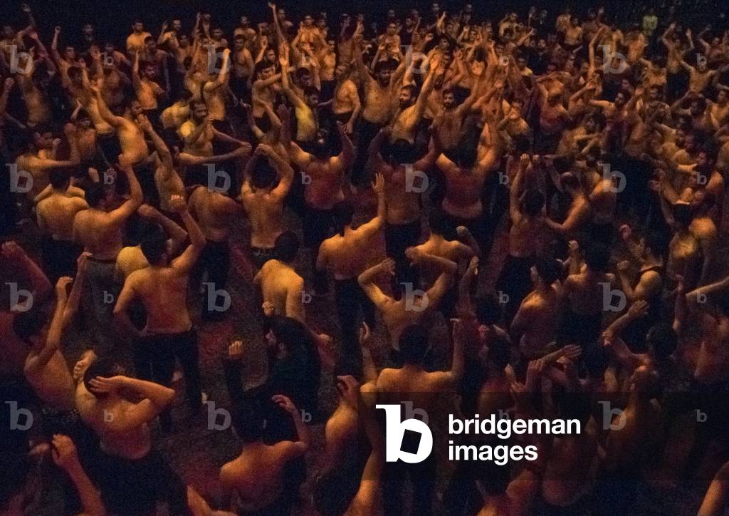 Iranian Shiite Muslim Mourners From the Mad of Hussein Community Chanting and Self-flagellating in Circle during Muharram, Isfahan Province, Kashan, Iran (photo)