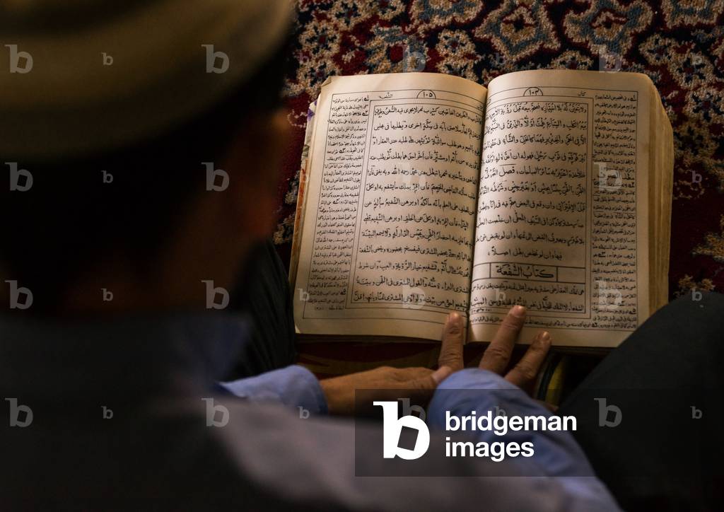 Iranian Shiite Muslim Student Reading the Koran in a Madrassah, Golestan Province, Karim Ishan, Iran (photo)