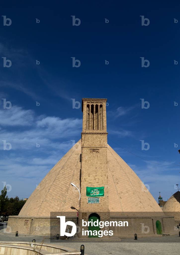 Wind towers used as a natural cooling system for water reservoir in Iranian traditional architecture, Isfahan Province, Nain, Iran (photo)