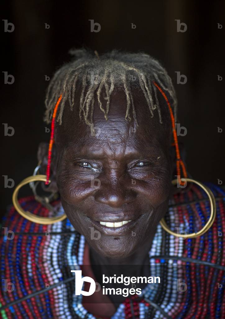 A pokot woman wears large necklaces made from the stems of sedge grass, Baringo county, Baringo, Kenya, Africa (photo)