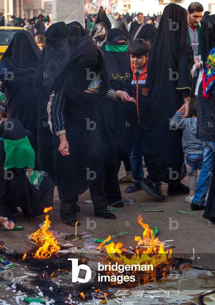 Iranian Women Light Candles during Chehel Menbari Festival on Tasua to Commemorate the Martyrdom Anniversary of Hussein, Lorestan Province, Khorramabad, Iran (photo)