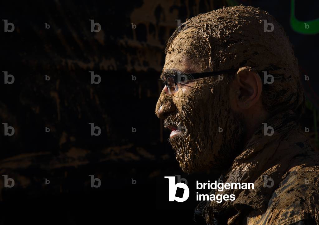Iranian Shiite Muslim Man with Glasses Covered in Mud during Ashura Day, Kurdistan Province, Bijar, Iran (photo)