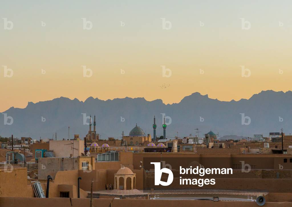View of the City with Traditional Wind Catchers and Mosques at Dusk, Yazd Province, Yazd, Iran (photo)