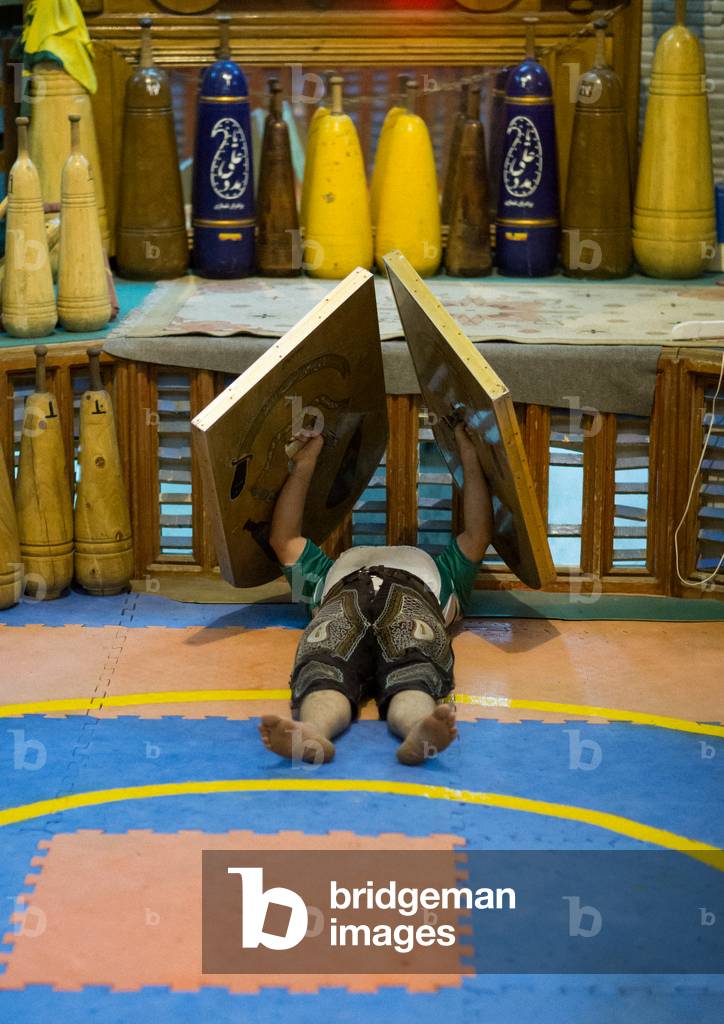 Iranian Man Training with Sangs in Saheb a Zaman Club Zurkhaneh, Yazd Province, Yazd, Iran (photo)