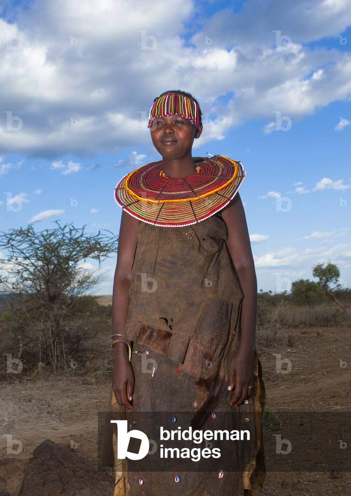 A pokot woman wears large necklaces made from the stems of sedge grass, Baringo county, Baringo, Kenya, Africa (photo)