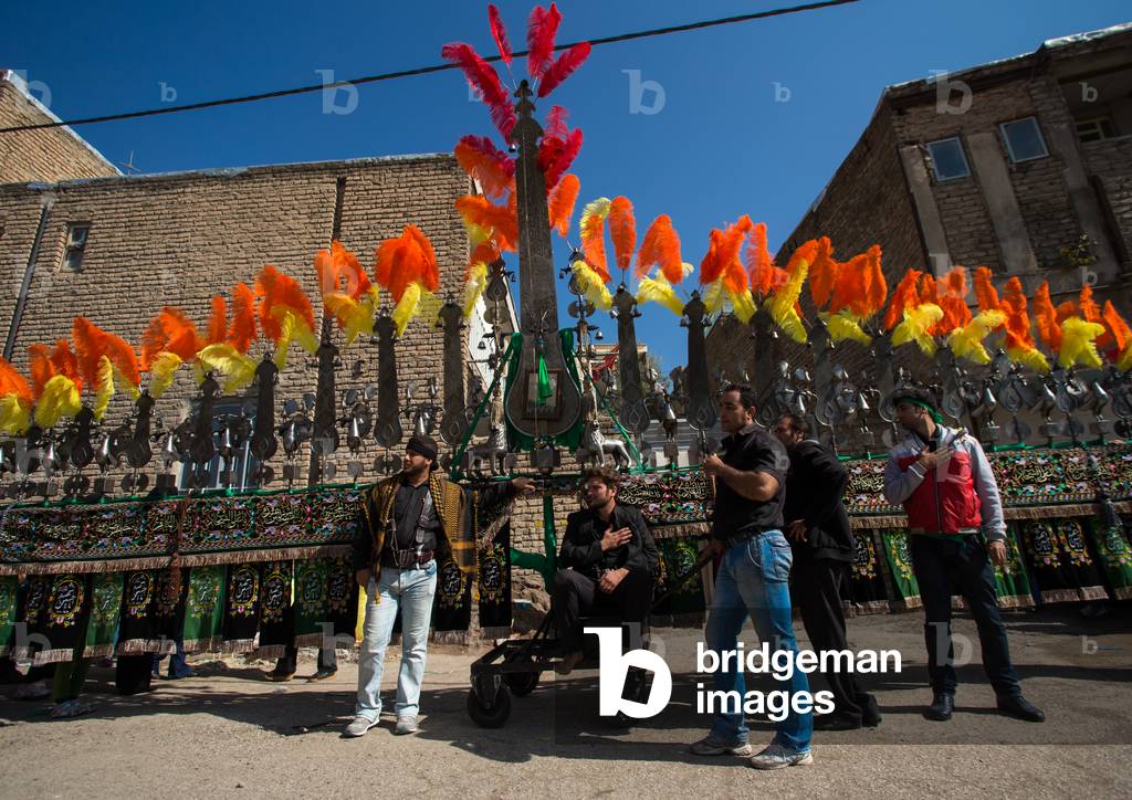Iranian Shiite Muslims Men in front of an An Alam on Tasua Celebration, Lorestan Province, Khorramabad, Iran (photo)