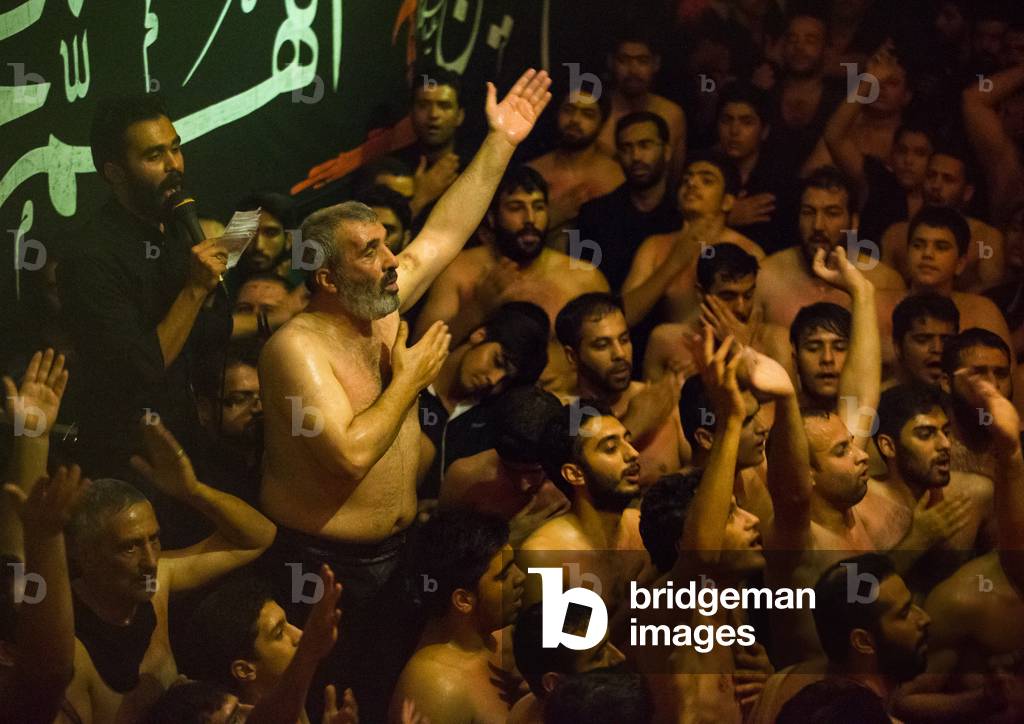 Iranian Shiite Muslim Man Leading Recitations and Songs with the Mad of Hussein Mourners during Muharram, Isfahan Province, Kashan, Iran (photo)