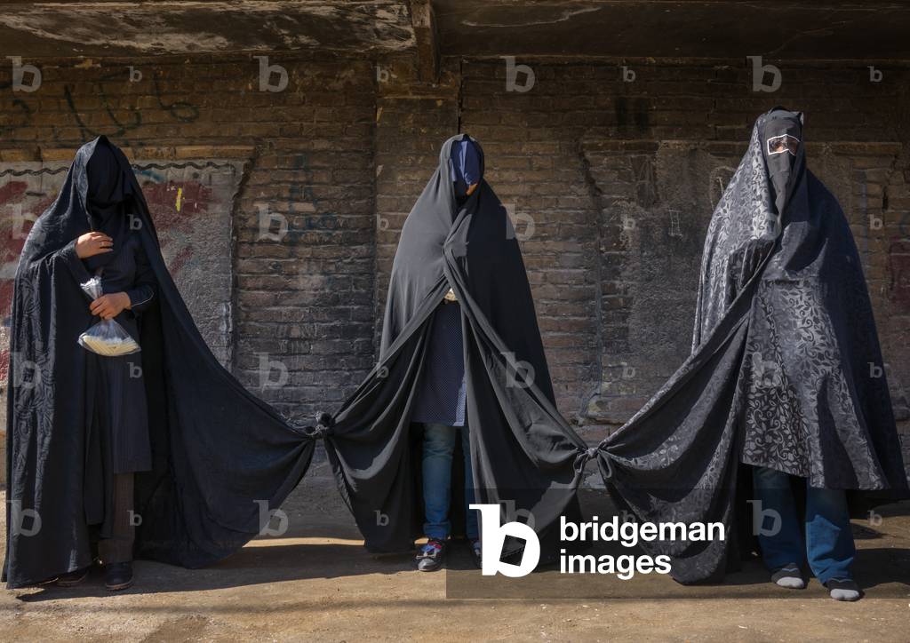 Iranian Shiite Women mourning Hussein on Tasua Day with their Faces Covered and their Clothes Tied As They Must Not Speak, Lorestan Province, Khorramabad, Iran (photo)