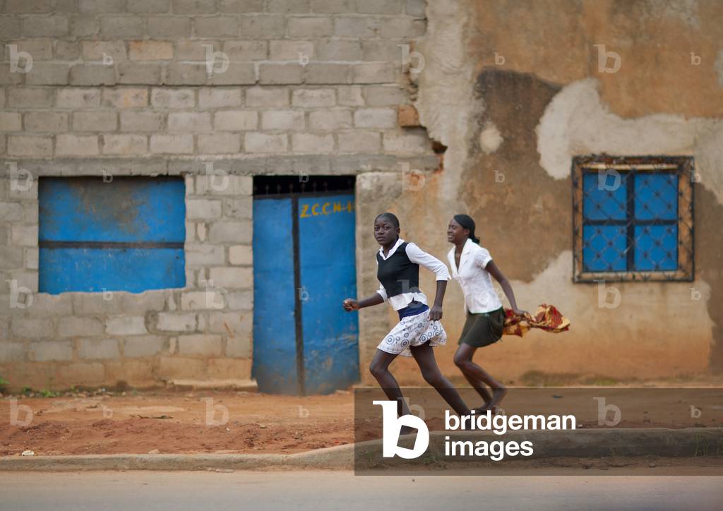 Girls Running in the Streets of Huambo, Angola, Africa (photo)