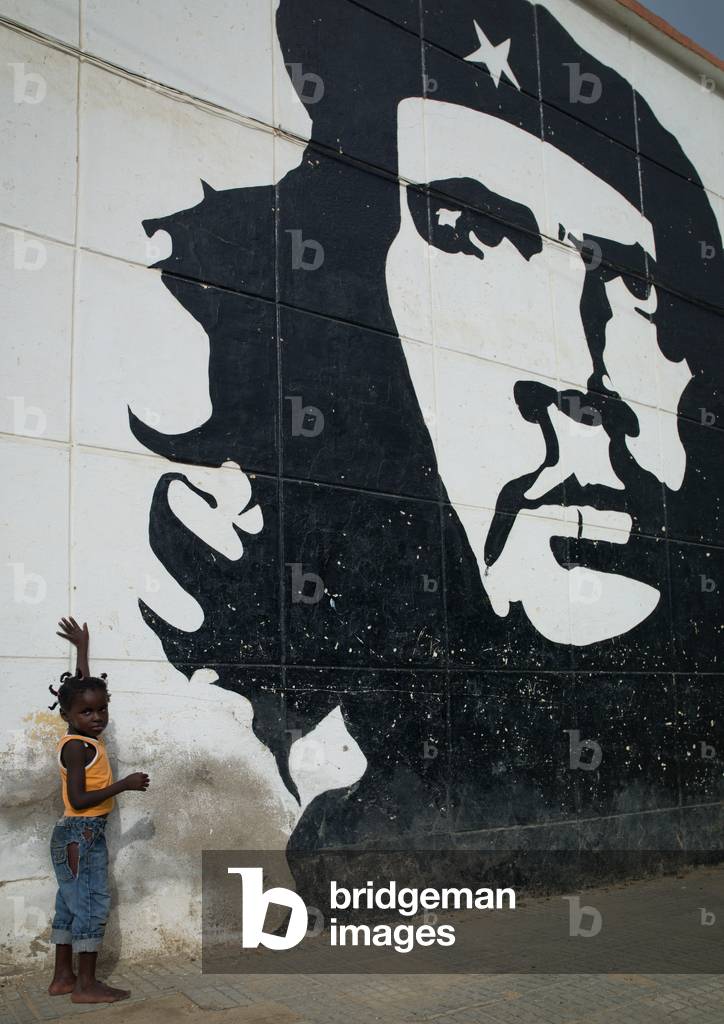 Young Girl Touching a Che Guevara Wall Painting, Sumbe, Angola, Africa (photo)