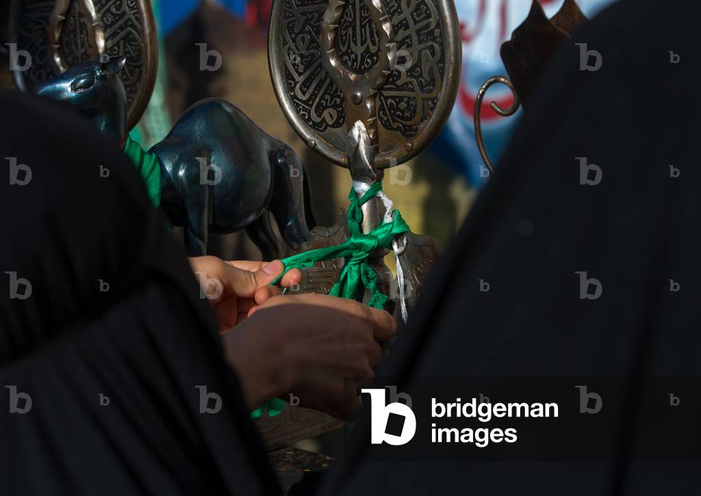 Iranian Shiite Women Putting Green Ribbons on an Alam to Make Wishes during Chehel Menbari Festival on Tasua Day, Lorestan Province, Khorramabad, Iran (photo)
