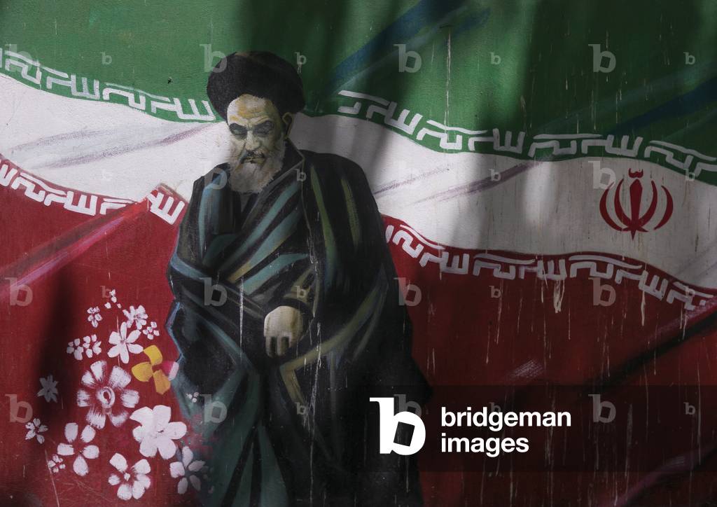 Propaganda sign with Ayatollah Khomeini on the wall of the former u.s. embassy, Shemiranat county, Tehran, Iran (photo)