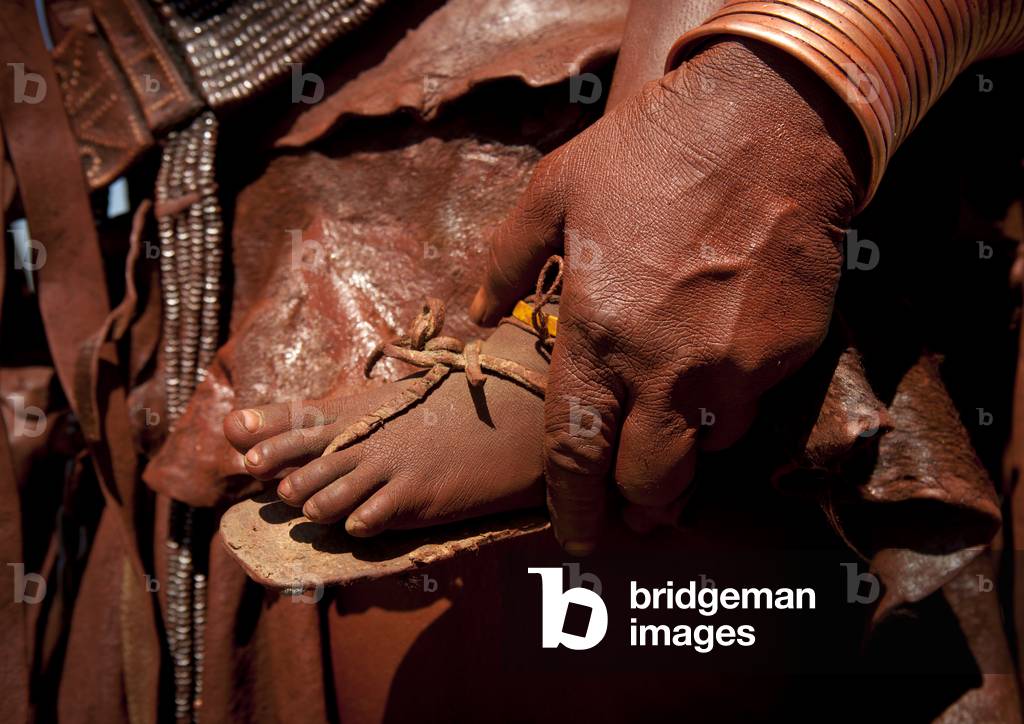 Hand of a Muhimba Woman holding a Baby Foot, Village of Elola, Angola, Africa (photo)