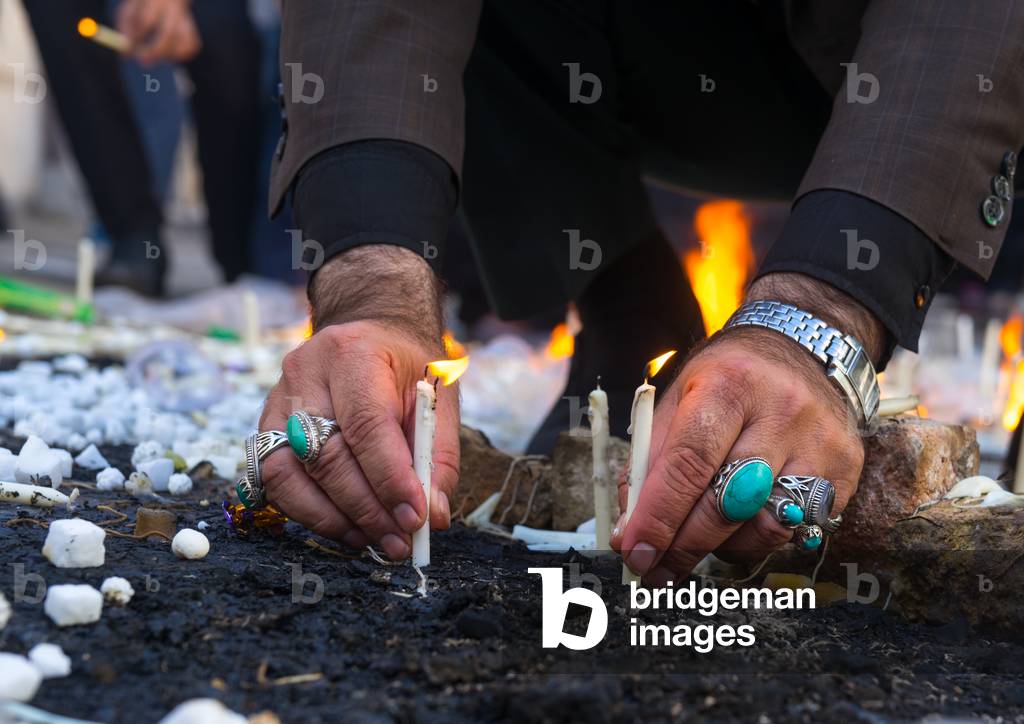 A Man Lights Candles during Chehel Menbari Festival on Tasu'a Day to Commemorate the Martyrdom Anniversary of Imam Hussein, Lorestan Province, Khorramabad, Iran (photo)