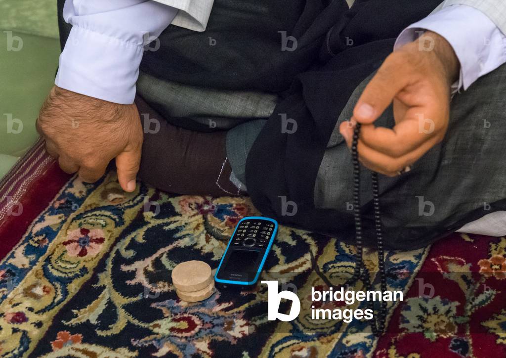 Iranian Shiite Muslim Man Praying in Fatima Al-masumeh Mosque, Fars Province, Shiraz, Iran (photo)