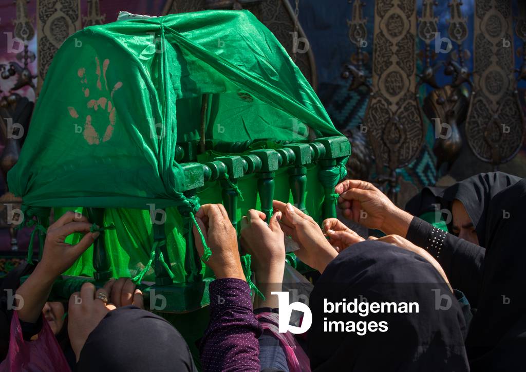 Iranian Shiite Women Putting Gren Ribbons on a Green Craddle to Make Wishes during Chehel Menbari Festival on Tasua Day, Lorestan Province, Khorramabad, Iran (photo)