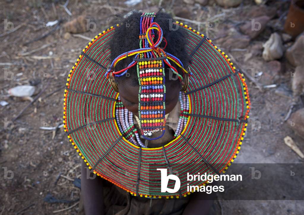 A pokot woman wears large necklaces made from the stems of sedge grass, Baringo county, Baringo, Kenya, Africa (photo)