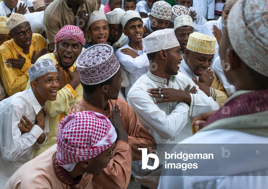 Sunni muslim men dancing during the maulidi festivities in the street, Lamu county, Lamu town, Kenya, Africa (photo)