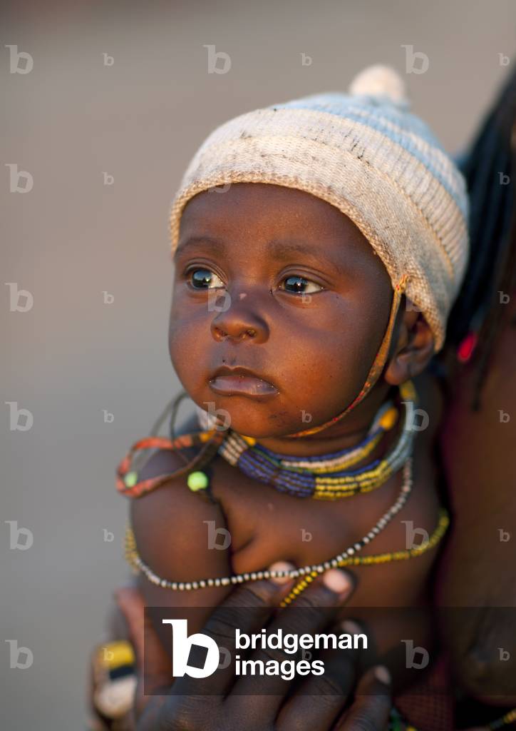 Mucawana Baby with a Wooly Hat, Village of Oncocua, Angola, Africa (photo)