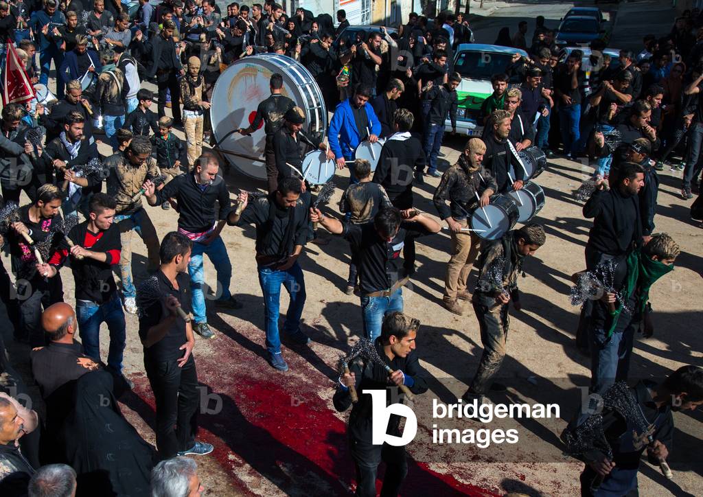 Iranian Shiite Men Covered in Mud beating themselves with Iron Chains, Kurdistan Province, Bijar, Iran (photo)