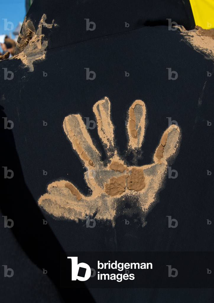 Iranian Shiite Muslim Woman with a Mud Handprint on her Back during Ashura, Kurdistan Province, Bijar, Iran (photo)