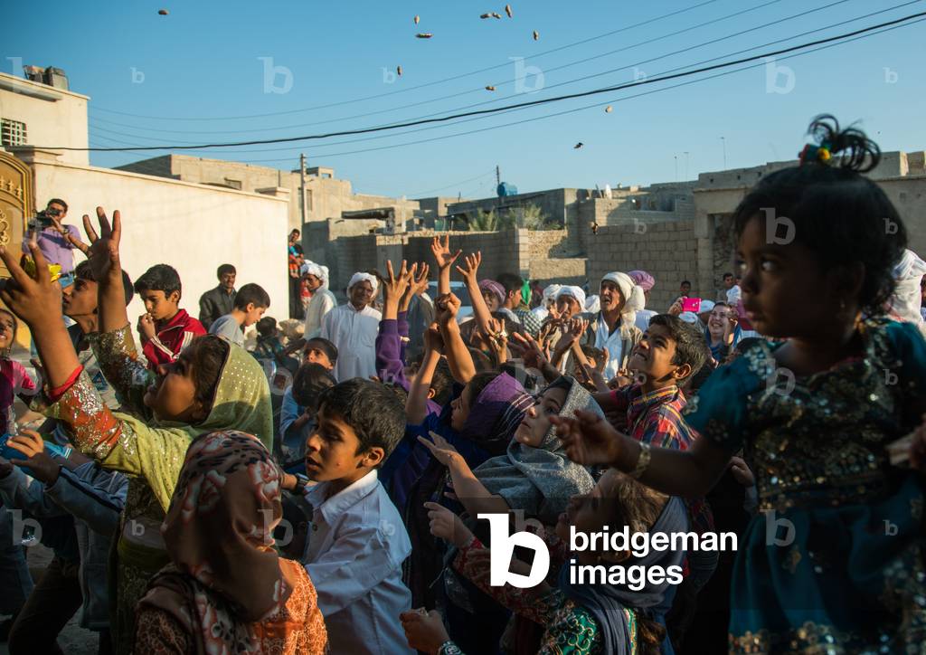 Children Catching Sweets Thrown From The House Roof During A Wedding Ceremony, Qeshm Island, Salakh, Iran, 2015 (photo)