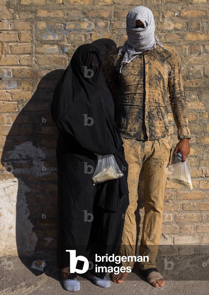 Iranian Shiite Muslim Couple mourning Imam Hussein on the Day of Tasua with their Faces Covered by a Veil, Lorestan Province, Khorramabad, Iran (photo)
