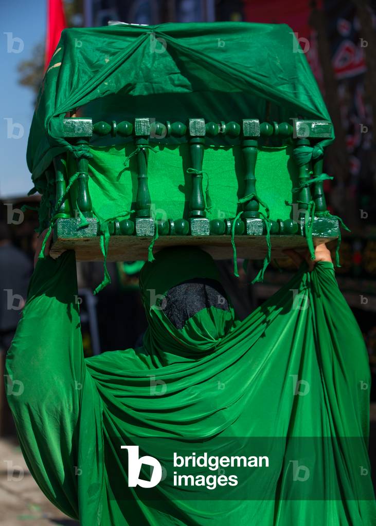 Iranian Shiite Muslim Woman on the Day of Tasua with her Face Covered by a Green Veil and Collecting Money in a Craddle, Lorestan Province, Khorramabad, Iran (photo)