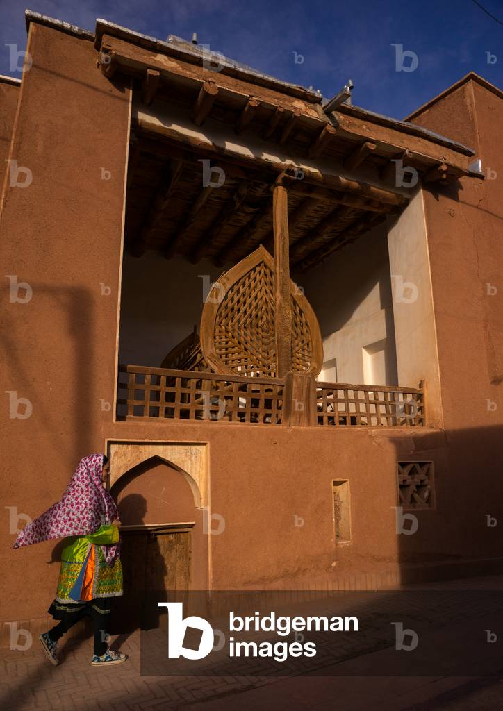 Woman Passing in front of a Nakhl in an Ancient Building in Zoroastrian Village, Isfahan Province, Abyaneh, Iran (photo)