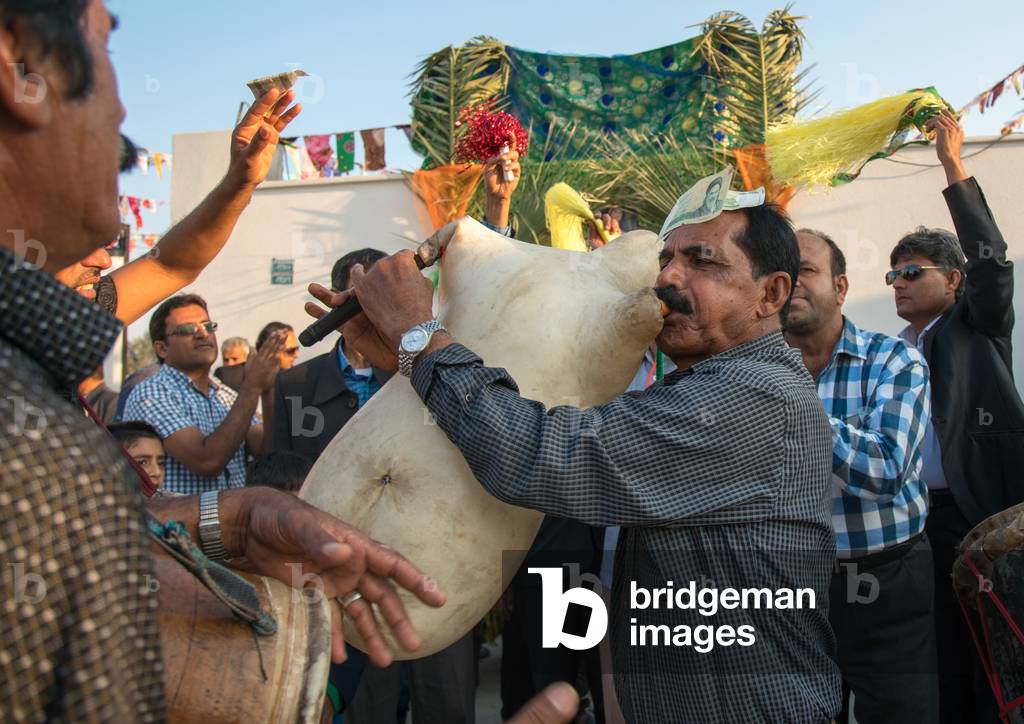 Men Playing Sheep Skin Pipe Bag During A Wedding Ceremony, Hormozgan, Kushkenar, Iran, 2015 (photo)