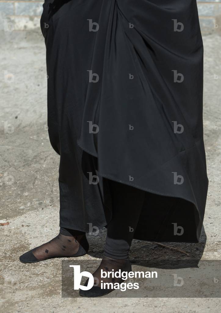 An Iranian Shiite Woman Walks in Stocking Feet during the Chehel Manbar Ceremony a Day before Ashura, Lorestan Province, Khorramabad, Iran (photo)