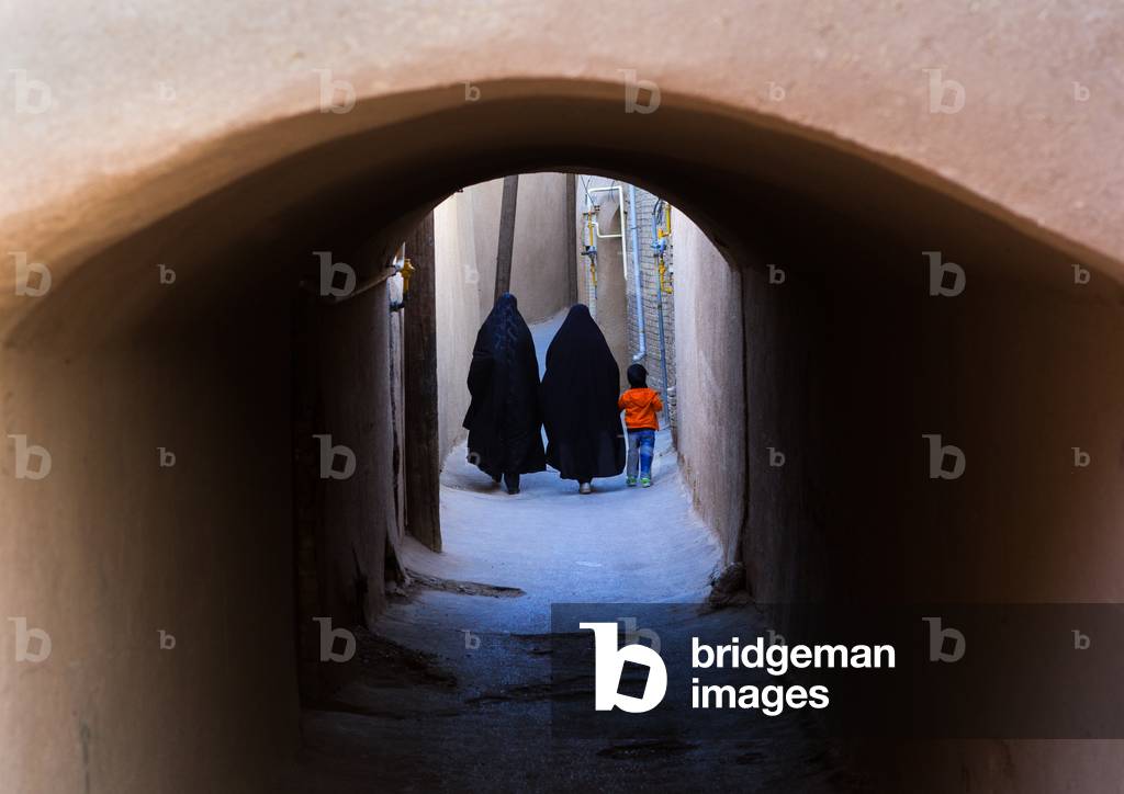 Women with a Child walking Ina Narrow Street with Arches, Yazd Province, Yazd, Iran (photo)