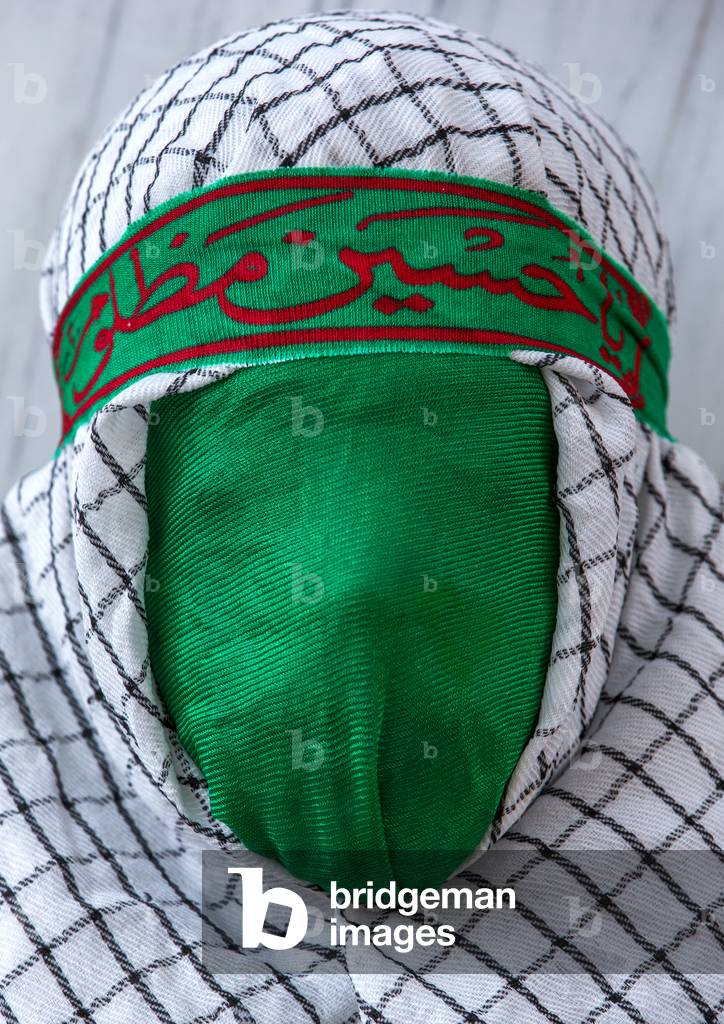 Iranian Young Man with Green Veil Covering His Face during Chehel Menbari Festival on Tasua to Commemorate the Martyrdom of Hussein, Lorestan Province, Khorramabad, Iran (photo)